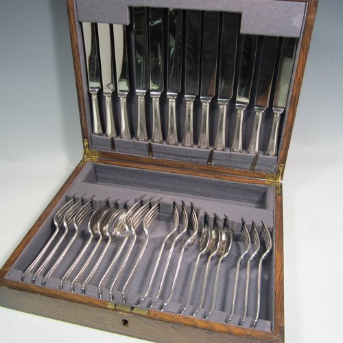 Sterling silver Belmont pattern flatware / cutlery service in original canteen, having 30 pieces in total, including 6 table forks, 6 dessert forks, 6 dessert spoons, 6 table knives, and 6 dessert knives. All made in Sheffield in 1939. The dimensions of this fine hand-made silver cutlery service are length of table fork 19 cms (7.5 inches), length of table knife 25.5 cms (10 inches), and the total weight is approx. 1,250g (40 troy ounces). Please note that the canteen has damage to the external veneer, and that the brass plaque on top of the box lid is monogrammed.