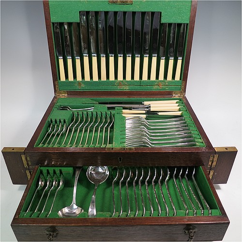 A very stylish Art Deco Sterling Silver Newlyn pattern flatware / cutlery service for nine people in original oak canteen, having 69 pieces total including 9 table forks, 9 dessert forks, 4 table spoons, 9 dessert spoons, 6 coffee spoons, 9 teaspoons, 9 bone-handled table knives, 9 bone-handled dessert knives, a pair of sauce ladles, and a 3-piece bone-handled carving set. All made by Frank Cobb an Co. Ltd., of Sheffield in 1936. The dimensions of this fine hand-made silver cutlery service are length of table fork 19 cms (7.5 inches), length of largest spoon 21 cms (8.25 inches), and the total weight is 2,170g (70 troy ounces).