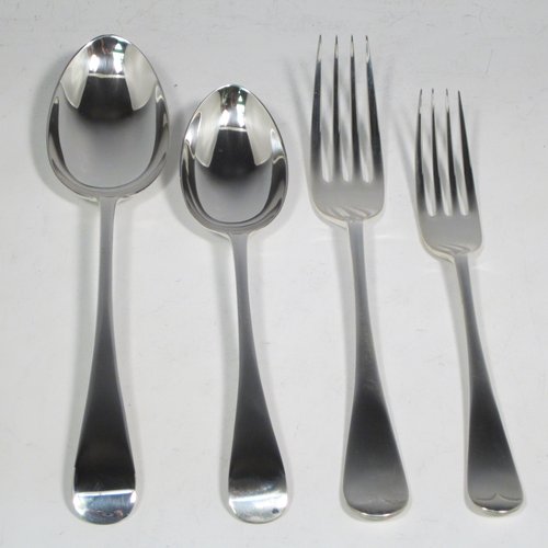 An Antique Edwardian Sterling Silver Old English pattern flatware / cutlery service for twelve people in an original oak canteen, having 56 pieces total including 12 table forks, 12 dessert forks, 12 dessert spoons, and 12 table spoons (6 of which are smaller and 6 larger). All made by Walker & Hall of Sheffield in 1905. The dimensions of this fine hand-made antique silver cutlery service are length of table fork 20 cms (8 inches), length of largest spoon 21.5 cms (8.5 inches), and the total weight is 2,726g (88 troy ounces). Please note that this set does not include knives, and that the brass plaque on top of the box lid has a presentation inscription.