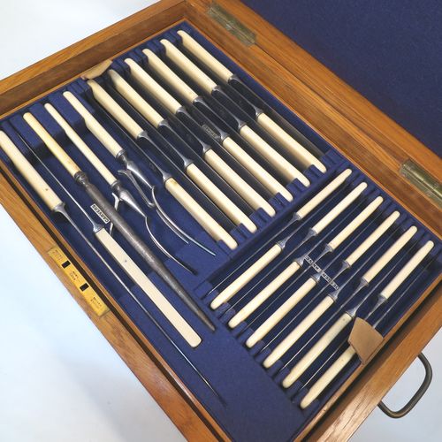 A very handsome and complete Antique Edwardian Silver Plated Old English pattern flatware / cutlery service for twelve people in original oak canteen with brass fitting, having 101 pieces total including 12 table forks, 12 dessert forks, 12 table / soup spoons, 12 dessert spoons, 12 tea spoons, 6 egg spoons, 12 bone-handled table knives, 12 bone-handled dessert knives, a butter knife, a condiment spoon, a pair of sugar nips, a pair of sauce ladles, a large soup ladle, and a 5-piece bone-handled carving set. All made by Harrison Brothers and Howson of Sheffield in ca. 1910.