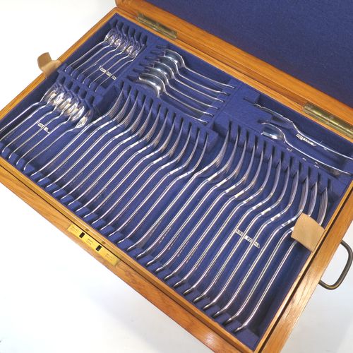 A very handsome and complete Antique Edwardian Silver Plated Old English pattern flatware / cutlery service for twelve people in original oak canteen with brass fitting, having 101 pieces total including 12 table forks, 12 dessert forks, 12 table / soup spoons, 12 dessert spoons, 12 tea spoons, 6 egg spoons, 12 bone-handled table knives, 12 bone-handled dessert knives, a butter knife, a condiment spoon, a pair of sugar nips, a pair of sauce ladles, a large soup ladle, and a 5-piece bone-handled carving set. All made by Harrison Brothers and Howson of Sheffield in ca. 1910.