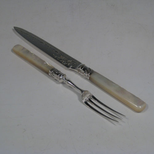 Antique Edwardian sterling silver and mother-of-pearl fruit set for 12 people. Having engraved knife blades and three-prong forks, fluted ferrules connecting the mother-of-pearl handles, and having green velvet storage rolls. Made by Allen and Darwin of Sheffield in 1907. Length of knife 18 cms (7 inches), length of fork 15 cms (6 inches). Please note that this set does NOT include the storage bags as they have been sold.