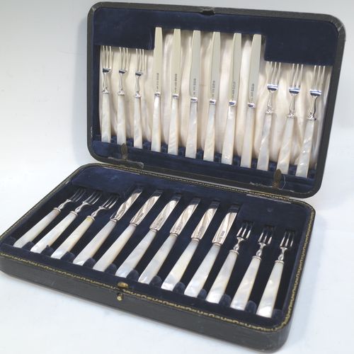 A very elegant Antique Sterling Silver and mother-of-pearl handled fruit set for twelve people. Having plain straight-sided pointed-end blade knives, and three-prong forks. All fitted into an original presentation box with cream satin and dark blue velvet interior. Made by James Dixon and Sons of Sheffield in 1925. The dimensions of this fine hand-made antique silver fruit service are length of knife 19 cms (7.5 inches), and the length of the fork 13.5 cms (5.25 inches).