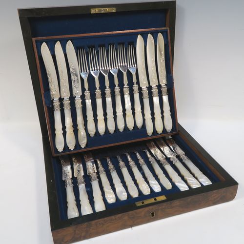 A beautiful Antique Victorian Sterling Silver and hand-carved mother-of-pearl handled fruit set for twelve people in its original dark blue velvet-lined and Walnut canteen box, with removable upper tray. The knives having slightly curved blades with silver ferrules and hand-engraved floral decoration. The forks having silver ferrules and four plain tines. This very pretty antique silver and mother-of-pearl fruit eating service was made by James Round of Sheffield over the period 1854 to 1865. The dimensions of this fine hand-made sterling silver and mother-of-pearl fruit set are length of knife 21 cms (8.25 inches), length of fork 18 cms (7 inches)   