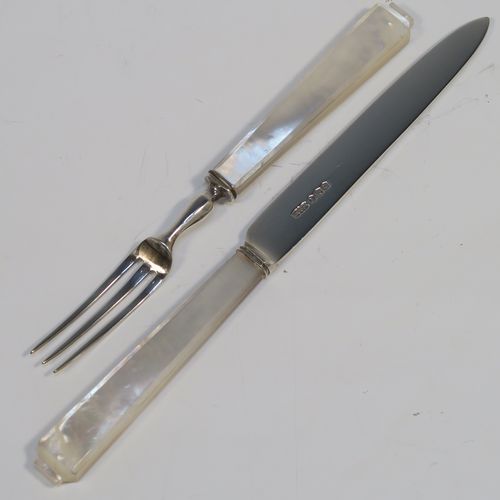 A very elegant Art Deco style Sterling Silver and mother-of-pearl handled fruit set for six people. Having plain straight-sided pointed-end blade knives, and three-prong forks. All fitted into an original wooden presentation box with black velvet-lined interior. This handsome silver fruit set was made by James Dixon and Sons of Sheffield in 1934. The dimensions of this fine hand-made silver and mother-of-pearl fruit service are length of knife 17 cms (6.75 inches), and the length of the fork 13.5 cms (5.3 inches).