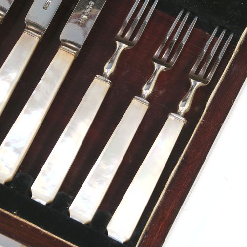 A very elegant Art Deco style Sterling Silver and mother-of-pearl handled fruit set for six people. Having plain straight-sided pointed-end blade knives, and three-prong forks. All fitted into an original wooden presentation box with black velvet-lined interior. This handsome silver fruit set was made by James Dixon and Sons of Sheffield in 1934. The dimensions of this fine hand-made silver and mother-of-pearl fruit service are length of knife 17 cms (6.75 inches), and the length of the fork 13.5 cms (5.3 inches).