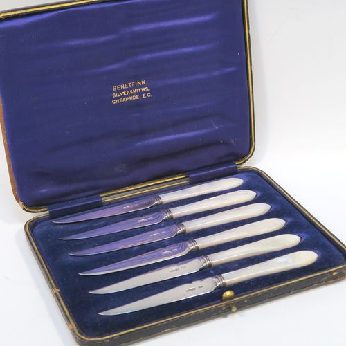 A very elegant set of six Antique Edwardian Sterling Silver and mother-of-pearl handled fruit fruit eating knives, having plain pointed-end bladed knives, all fitted into an original dark blue satin and velvet-line presentation box. This handsome silver fruit eater set was made by Allen and Darwin of Sheffield in 1903. The dimensions of this fine set of hand-made silver and mother-of-pearl fruit knives are length 16.5 cms (6.5 inches). Please note that the box is slightly damaged on one side.