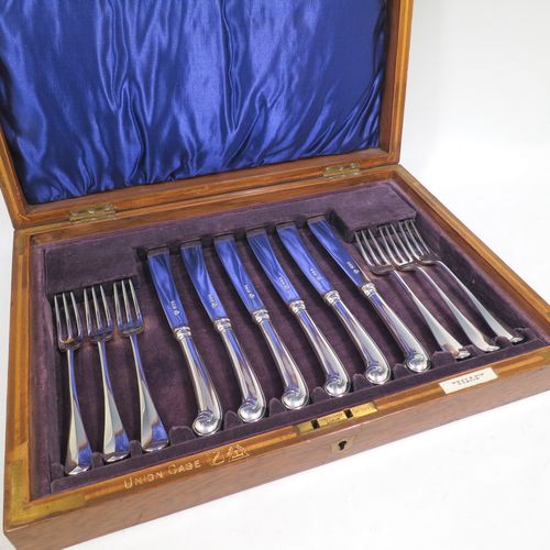 A very handsome Antique Sterling Silver fruit set for six people, in the early Hanoverian pattern, with three-prong forks and pistol-handled kives with spatular blades, all fitted into an original wooden presentation box with dark blue satin and velvet-lined interior. Made by West and Sons of London in 1916. The dimensions of this fine hand-made silver fruit service are length of knife 20.5 cms (8 inches), and the length of the fork 16.5 cms (6.5 inches).    