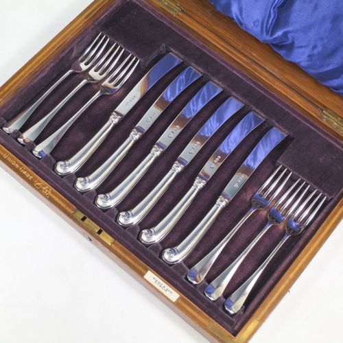 A very handsome Antique Sterling Silver fruit set for six people, in the early Hanoverian pattern, with three-prong forks and pistol-handled kives with spatular blades, all fitted into an original wooden presentation box with dark blue satin and velvet-lined interior. Made by West and Sons of London in 1916. The dimensions of this fine hand-made silver fruit service are length of knife 20.5 cms (8 inches), and the length of the fork 16.5 cms (6.5 inches).
