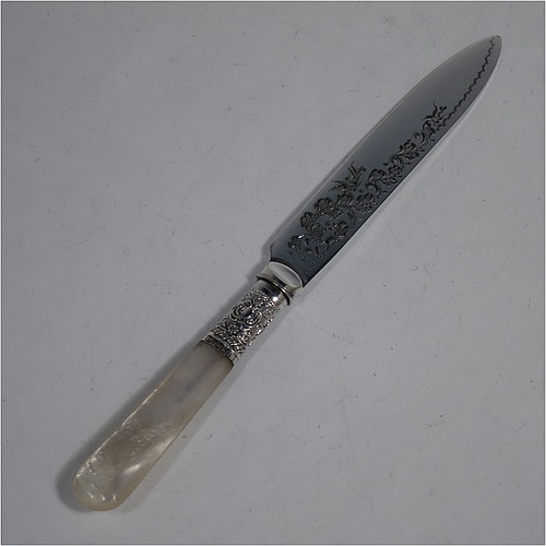An Antique Victorian silver-plated and mother-of-pearl handled fruit set for twelve people, having hand-engraved tapering bladed knives and four-prong forks with floral decoration, with large hand-chased silver ferrules connecting the mother-of-pearl handles, all fitted into their original maroon satin and velvet-lined presentation box. The ferrules are of hallmarked sterling silver and are made by John Sanderson of Sheffield in 1897. The dimensions of this fine hand-made antique silver fruit service are length of knife 21 cms (8.25 inches), and the length of the fork 17.5 cms (7 inches).