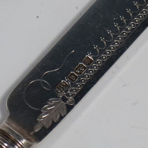 An Antique Edwardian Sterling Silver and mother-of-pearl handled fruit set for twelve people. Having straight-sided rounded-end blade knives, and four-prong forks, with hand-engraved floral decoration, and reed-work ferrules, all fitted into an original presentation box with dark blue velvet interior. Made by George Hancock of Sheffield in 1908. The dimensions of this fine hand-made antique silver fruit service are length of knife 19 cms (7.5 inches), and the length of the fork 15 cms (6 inches).
