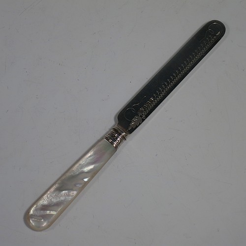 An Antique Edwardian Sterling Silver and mother-of-pearl handled fruit set for twelve people. Having straight-sided rounded-end blade knives, and four-prong forks, with hand-engraved floral decoration, and reed-work ferrules, all fitted into an original presentation box with dark blue velvet interior. Made by George Hancock of Sheffield in 1908. The dimensions of this fine hand-made antique silver fruit service are length of knife 19 cms (7.5 inches), and the length of the fork 15 cms (6 inches).