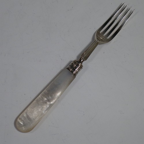 An Antique Edwardian Sterling Silver and mother-of-pearl handled fruit set for twelve people. Having straight-sided rounded-end blade knives, and four-prong forks, with hand-engraved floral decoration, and reed-work ferrules, all fitted into an original presentation box with dark blue velvet interior. Made by George Hancock of Sheffield in 1908. The dimensions of this fine hand-made antique silver fruit service are length of knife 19 cms (7.5 inches), and the length of the fork 15 cms (6 inches).
