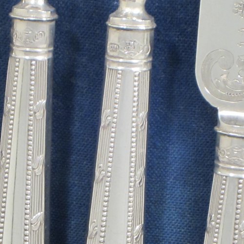 Antique Victorian sterling silver fruit set for twelve people, having hand-engraved floral decoration on the blades and four-prong forks, and the handles in a very pretty pattern with reeding and bead-work, all fitted into an original wooden presentation box with dark blue velvet interior. Made by Thomas Bradbury and Sons of Sheffield in 1883. The dimensions of this fine hand-made silver fruit service are length of knife 21.5 cms (8.5 inches), and the length of the fork 18.5 cms (7.25 inches).