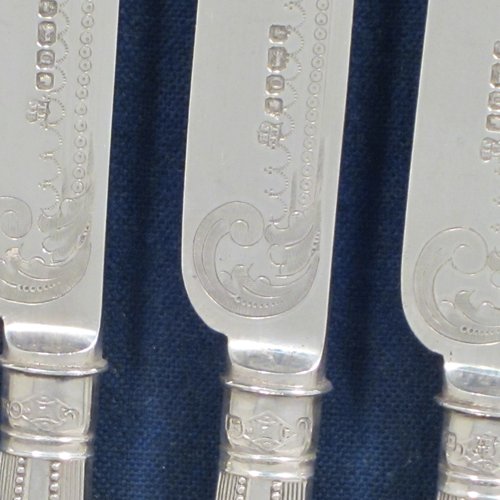 Antique Victorian sterling silver fruit set for twelve people, having hand-engraved floral decoration on the blades and four-prong forks, and the handles in a very pretty pattern with reeding and bead-work, all fitted into an original wooden presentation box with dark blue velvet interior. Made by Thomas Bradbury and Sons of Sheffield in 1883. The dimensions of this fine hand-made silver fruit service are length of knife 21.5 cms (8.5 inches), and the length of the fork 18.5 cms (7.25 inches).