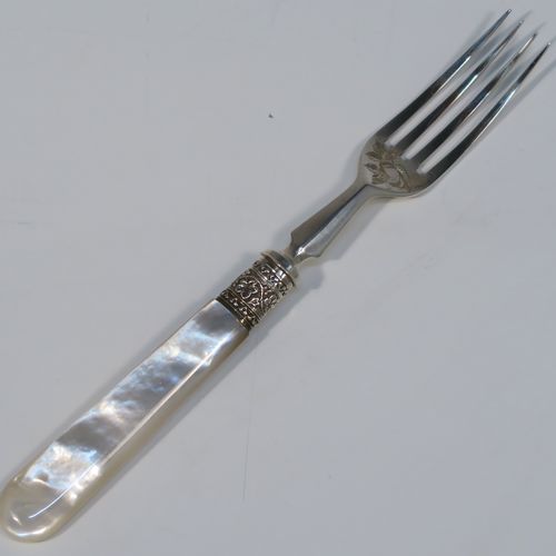 A beautiful Antique Victorian Sterling Silver and mother-of-pearl handled fruit set for 12 people. Having parallel bladed knives and four-prong forks, all hand-engraved with floral decoration, together with ivy-work ferrules connecting the mother-of-pearl handles, and fitted into an original oak canteen with removable top tray and dark blue velvet interior. This very pretty silver and mother-of-pearl fruit eating set was made by Joseph Rogers of Sheffield in 1883. The dimensions of this fine hand-made silver fruit set are length of knife 20 cms (8 inches), length of fork 16.5 cms (6.5 inches).