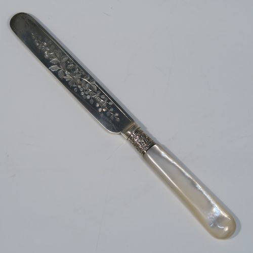 A beautiful Antique Victorian Sterling Silver and mother-of-pearl handled fruit set for 12 people. Having parallel bladed knives and four-prong forks, all hand-engraved with floral decoration, together with ivy-work ferrules connecting the mother-of-pearl handles, and fitted into an original oak canteen with removable top tray and dark blue velvet interior. This very pretty silver and mother-of-pearl fruit eating set was made by Joseph Rogers of Sheffield in 1883. The dimensions of this fine hand-made silver fruit set are length of knife 20 cms (8 inches), length of fork 16.5 cms (6.5 inches).