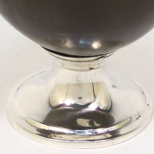 An elegant Antique Georgian Sterling Silver Coconut mounted goblet, with an applied vacant cartouche on one side, a plain round top border, and sitting on a plain round pedestal foot. This handsome antique silver and coconut goblet was made by Charles and David Reid of Newcastle in 1829. The dimensions of this fine hand-made silver and coconut goblet are height 11.5 cms (4.5 inches), and diameter of main body 9.5 cms (3.75 inches).