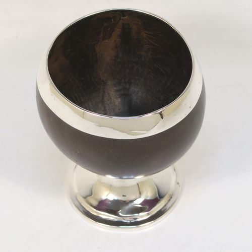 An elegant Antique Georgian Sterling Silver Coconut mounted goblet, with an applied vacant cartouche on one side, a plain round top border, and sitting on a plain round pedestal foot. This handsome antique silver and coconut goblet was made by Charles and David Reid of Newcastle in 1829. The dimensions of this fine hand-made silver and coconut goblet are height 11.5 cms (4.5 inches), and diameter of main body 9.5 cms (3.75 inches).