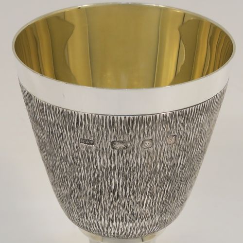 A very unusual modernistic style Sterling Silver sherry or fortified wine goblet, having a round tapering body with a hand-chased bark-like finish, a gold-gilt interior, and sitting on a plain round pedestal foot. This handsome silver sherry goblet was made by RAF of London in 1971. The dimensions of this fine hand-made silver goblet are height 11 cms (4.3 inches), diameter at lip 7.5 cms (3 inches), and it weighs approx. 164g (5.3 troy ounces).
