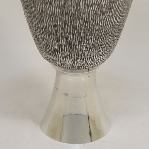 A very unusual modernistic style Sterling Silver sherry or fortified wine goblet, having a round tapering body with a hand-chased bark-like finish, a gold-gilt interior, and sitting on a plain round pedestal foot. This handsome silver sherry goblet was made by RAF of London in 1971. The dimensions of this fine hand-made silver goblet are height 11 cms (4.3 inches), diameter at lip 7.5 cms (3 inches), and it weighs approx. 164g (5.3 troy ounces).