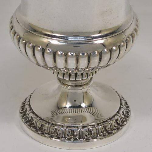 A beautiful Antique Georgian Sterling Silver Regency goblet, having a hand-chased Campagna style body, with an applied band of grapevine decoration, a half-fluted lower body, a gold-gilt interior, and sitting on a pedestal foot. This handsome antique silver Regency style goblet was made by Robert Garrard of London in 1822. The dimensions of this fine hand-made antique silver goblet are height 13.5 cms (5.3 inches), diameter at lip 9 cms (3.5 inches), and it weighs approx. 283g (9 troy ounces).