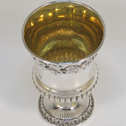 A beautiful Antique Georgian Sterling Silver Regency goblet, having a hand-chased Campagna style body, with an applied band of grapevine decoration, a half-fluted lower body, a gold-gilt interior, and sitting on a pedestal foot. This handsome antique silver Regency style goblet was made by Robert Garrard of London in 1822. The dimensions of this fine hand-made antique silver goblet are height 13.5 cms (5.3 inches), diameter at lip 9 cms (3.5 inches), and it weighs approx. 283g (9 troy ounces).