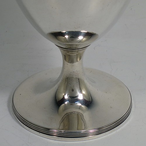 A very handsome pair of Antique Georgian Sterling Silver goblets, having plain round bodies with tapering sides, and sitting on pedestal feet with reeded borders. Made by John Robins of London in 1800. The dimensions of this fine hand-made pair of antique silver goblets are height 12 cms (4.75 inches), diameter at top 8 cms (3 inches), and the total weight is approx. 384g (12.4 troy ounces).