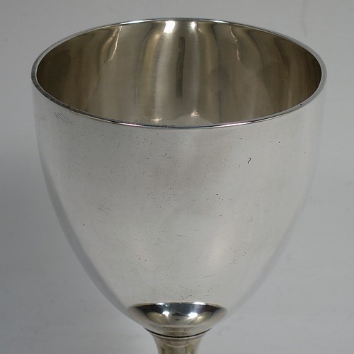A very handsome pair of Antique Georgian Sterling Silver goblets, having plain round bodies with tapering sides, and sitting on pedestal feet with reeded borders. Made by John Robins of London in 1800. The dimensions of this fine hand-made pair of antique silver goblets are height 12 cms (4.75 inches), diameter at top 8 cms (3 inches), and the total weight is approx. 384g (12.4 troy ounces).