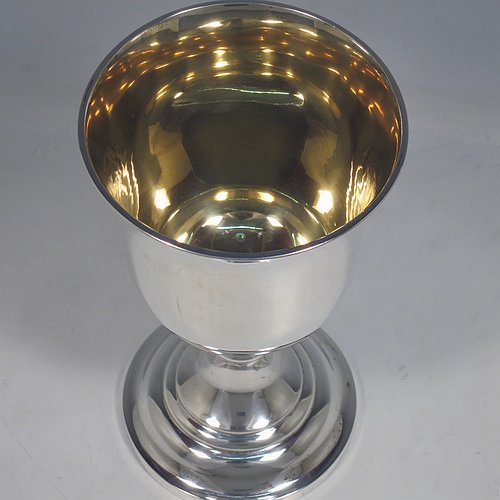 A large Antique Victorian Sterling Silver goblet, having a plain round baluster body with applied reeded border, hand-engraved on one side with a contemporaneous full inscription, a gold-gilt interior, and sitting on a pedestal foot. This handsome silver goblet was made by Walker & Hall of Sheffield in 1901. The dimensions of this fine hand-made antique silver goblet are height 19.5 cms (7.75 inches), diameter at lip 11 cms (4.25 inches), and it weighs approx. 375g (12 troy ounces).