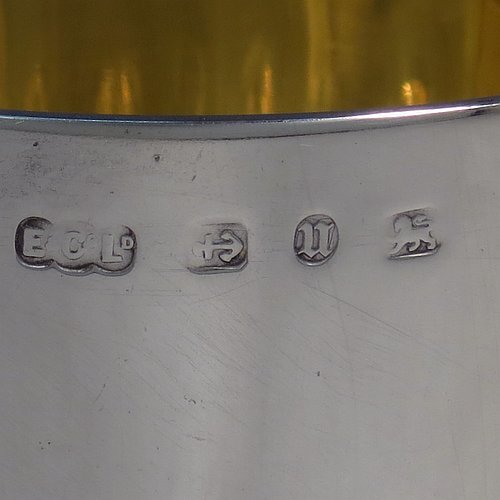 A large Antique Victorian Sterling Silver goblet, having a round tapering body with hand-chased half-fluted swirl and floral decoration, sitting on a pedestal foot, and with a gold-gilt interior. Made by Elkington & co., of Birmingham in 1894. The dimensions of this fine hand-made antique silver goblet are height 21.5 cms (8.5 inches), diameter at lip 10 cms (4 inches), and it weighs approx. 242g (7.8 troy ounces).