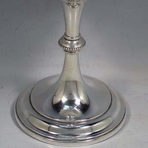 A large Antique Victorian Sterling Silver goblet, having a round tapering body with hand-chased half-fluted swirl and floral decoration, sitting on a pedestal foot, and with a gold-gilt interior. Made by Elkington & co., of Birmingham in 1894. The dimensions of this fine hand-made antique silver goblet are height 21.5 cms (8.5 inches), diameter at lip 10 cms (4 inches), and it weighs approx. 242g (7.8 troy ounces).