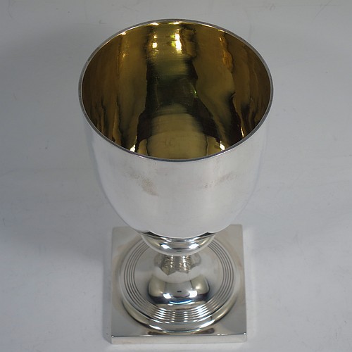 A very handsome Antique Georgian Sterling Silver heavy goblet, having a plain round tapering body with a gold-gilt interior, and sitting on a pedestal foot with reeded decoration and a square base. Made by Thomas Hobbs of London in 1811. The dimensions of this fine hand-made antique silver goblet are height 17 cms (6.75 inches), diameter at lip 9 cms (3.5 inches), and it weighs approx. 312g (10 troy ounces).