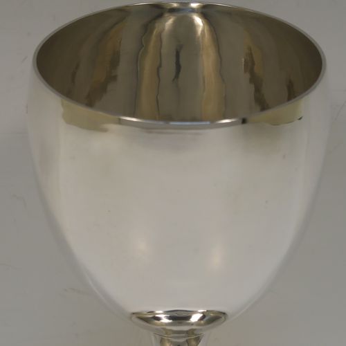 A handsome Antique Georgian Sterling Silver goblet, having a plain round bellied body, sitting on a plain round pedestal foot. This elegant silver goblet was made by Thomas Hobbs of London in 1814. The dimensions of this fine hand-made antique silver goblet are height 15 cms (6 inches), diameter at lip 8.5 cms (3.3 inches), and it weighs approx. 160g (5.2 troy ounces).