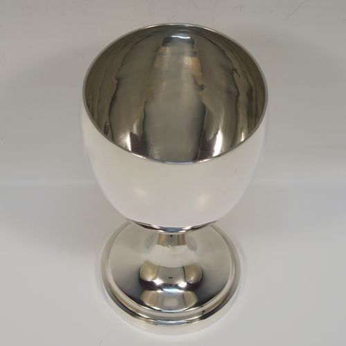 A handsome Antique Georgian Sterling Silver goblet, having a plain round bellied body, sitting on a plain round pedestal foot. This elegant silver goblet was made by Thomas Hobbs of London in 1814. The dimensions of this fine hand-made antique silver goblet are height 15 cms (6 inches), diameter at lip 8.5 cms (3.3 inches), and it weighs approx. 160g (5.2 troy ounces).