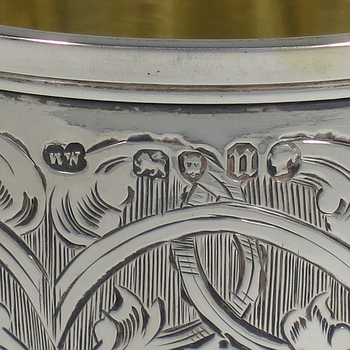 A very pretty Antique Victorian Sterling Silver goblet, having a round bellied body with hand-engraved floral and scroll decoration, with a vacant cartouche on one side, a gold-gilt interior, and sitting on a pedestal foot with hand-engraved decoration and applied bead-edged borders. Made by Henry Wilkinson of London in 1868. The dimensions of this fine hand-made antique silver goblet are height 16.5 cms (6.5 inches), diameter at lip 7.5 cms (3 inches), and it weighs approx. 148g (4.8 troy ounces).