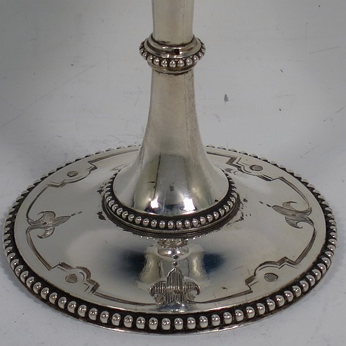 A very pretty Antique Victorian Sterling Silver goblet, having a round bellied body with hand-engraved floral and scroll decoration, with a vacant cartouche on one side, a gold-gilt interior, and sitting on a pedestal foot with hand-engraved decoration and applied bead-edged borders. Made by Henry Wilkinson of London in 1868. The dimensions of this fine hand-made antique silver goblet are height 16.5 cms (6.5 inches), diameter at lip 7.5 cms (3 inches), and it weighs approx. 148g (4.8 troy ounces).