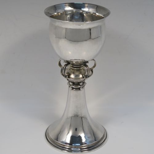 A unique and beautiful Antique Sterling Silver Arts and Crafts style goblet, having a round hand-hammered and bellied body sitting over a central baluster with five applied bands and bead-work, and all sitting on a plain spreading foot. This stunning silver goblet was made by Omar Ramsden of London in 1917. The dimensions of this fine hand-made antique silver Art and Crafts goblet are height 18 cms (7 inches), diameter at lip 8 cms (3.25 inches), and it weighs approx. 173g (5.6 troy ounces). Engraved underneath with Omar Ramsden Me Fecit.