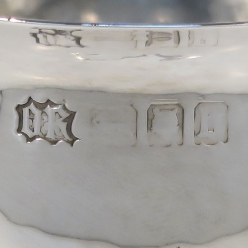 A unique and beautiful Antique Sterling Silver Arts and Crafts style goblet, having a round hand-hammered and bellied body sitting over a central baluster with five applied bands and bead-work, and all sitting on a plain spreading foot. This stunning silver goblet was made by Omar Ramsden of London in 1917. The dimensions of this fine hand-made antique silver Art and Crafts goblet are height 18 cms (7 inches), diameter at lip 8 cms (3.25 inches), and it weighs approx. 173g (5.6 troy ounces). Engraved underneath with Omar Ramsden Me Fecit.