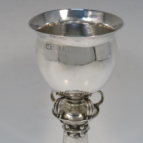 A unique and beautiful Antique Sterling Silver Arts and Crafts style goblet, having a round hand-hammered and bellied body sitting over a central baluster with five applied bands and bead-work, and all sitting on a plain spreading foot. This stunning silver goblet was made by Omar Ramsden of London in 1917. The dimensions of this fine hand-made antique silver Art and Crafts goblet are height 18 cms (7 inches), diameter at lip 8 cms (3.25 inches), and it weighs approx. 173g (5.6 troy ounces). Engraved underneath with Omar Ramsden Me Fecit.
