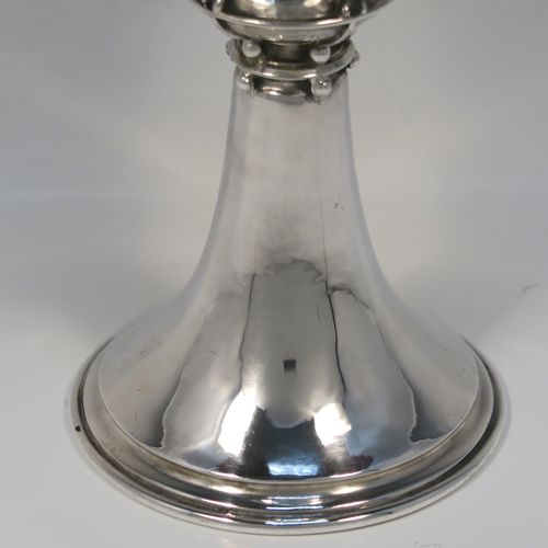 A unique and beautiful Antique Sterling Silver Arts and Crafts style goblet, having a round hand-hammered and bellied body sitting over a central baluster with five applied bands and bead-work, and all sitting on a plain spreading foot. This stunning silver goblet was made by Omar Ramsden of London in 1917. The dimensions of this fine hand-made antique silver Art and Crafts goblet are height 18 cms (7 inches), diameter at lip 8 cms (3.25 inches), and it weighs approx. 173g (5.6 troy ounces). Engraved underneath with Omar Ramsden Me Fecit.