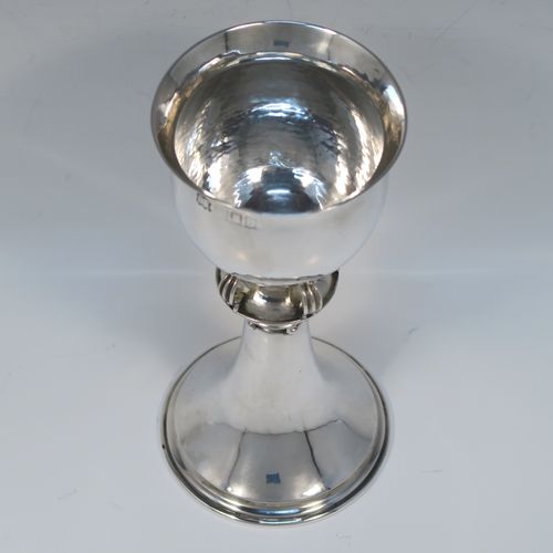 A unique and beautiful Antique Sterling Silver Arts and Crafts style goblet, having a round hand-hammered and bellied body sitting over a central baluster with five applied bands and bead-work, and all sitting on a plain spreading foot. This stunning silver goblet was made by Omar Ramsden of London in 1917. The dimensions of this fine hand-made antique silver Art and Crafts goblet are height 18 cms (7 inches), diameter at lip 8 cms (3.25 inches), and it weighs approx. 173g (5.6 troy ounces). Engraved underneath with Omar Ramsden Me Fecit.