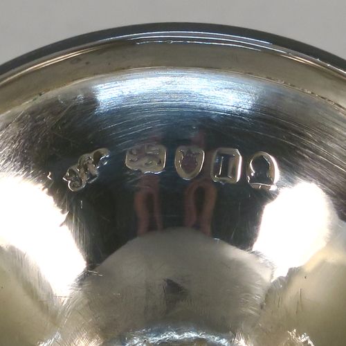 A very pretty Antique Georgian Sterling Silver goblet, having a round tapering body with a top band of hand-engraved floral and scroll decoration, sitting on a pedestal foot with a reeded border and matching engraving, and with a gold-gilt interior. This beautiful antique silver goblet was made John Emes of London in 1804. The dimensions of this fine hand-made antique silver goblet are height 14 cms (5.5 inches), diameter at lip 8 cms (3 inches), and it weighs approx. 158g (5 troy ounces).   
