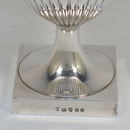 A very fine and handsome Antique Georgian Sterling Silver pair of goblets, having round bodies with hand-chased half-fluted decoration, gold-gilt interiors, and sitting on pedestal feet with square bases. Made by John Wakelin and Robert Garrard of London in 1796. The dimensions of this fine hand-made pair of antique silver goblets are height 15 cms (6 inches), diameter at top 9.5 cms (3.75 inches), and their total weight is approx. 509g (16.5 troy ounces).