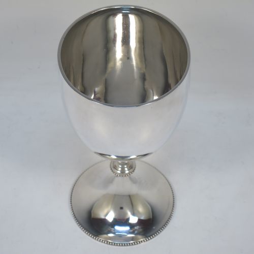 A pretty Antique Victorian Sterling Silver goblet, having a plain round tapering body, and sitting on a pedestal foot with an applied bead-edged border. Made by Edward Hutton of London in 1881. The dimensions of this fine hand-made antique silver goblet are height 16 cms (6.3 inches), diameter at lip 8.5 cms (3.3 inches), and it weighs approx. 212g (6.8 troy ounces).  