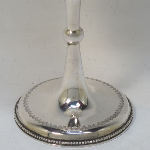 A very pretty Antique Victorian Sterling Silver goblet, having a round straight-sided and bellied body with hand-engraved floral and wheat-sheaf decoration, with a vacant cartouche on one side, a gold-gilt interior, and sitting on a pedestal foot with hand-engraved decoration and an applied bead-edged border. Made by George Maudsley Jackson of London in 1892. The dimensions of this fine hand-made antique silver goblet are height 18.5 cms (7.3 inches), diameter at lip 8.5 cms (3.3 inches), and it weighs approx. 175g (5.6 troy ounces).  