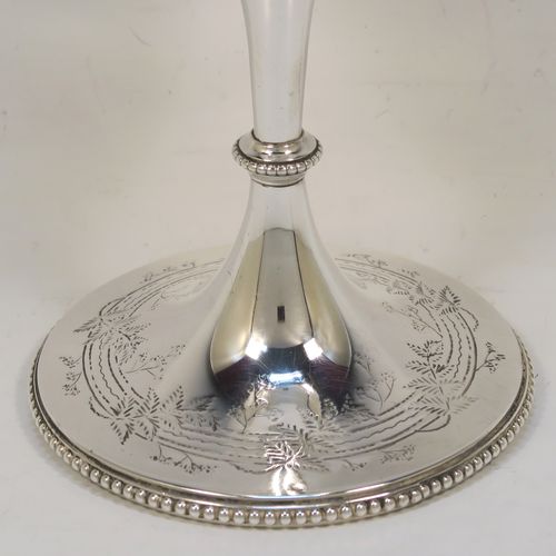A very pretty Antique Victorian Sterling Silver goblet, having a round straight-sided and bellied body with hand-engraved floral and fern decoration, a gold-gilt interior, and sitting on a pedestal foot with hand-engraved decoration and an applied bead-edged border. This beautiful antique silver goblet was made by Frederick Elkington of London in 1873. The dimensions of this fine hand-made antique silver goblet are height 18.5 cms (7.25 inches), diameter at lip 9 cms (3.5 inches), and it weighs approx. 205g (6.6 troy ounces).