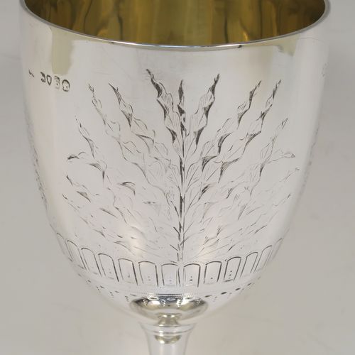 A very pretty Antique Victorian Sterling Silver goblet, having a round straight-sided and bellied body with hand-engraved floral and fern decoration, a gold-gilt interior, and sitting on a pedestal foot with hand-engraved decoration and an applied bead-edged border. This beautiful antique silver goblet was made by Frederick Elkington of London in 1873. The dimensions of this fine hand-made antique silver goblet are height 18.5 cms (7.25 inches), diameter at lip 9 cms (3.5 inches), and it weighs approx. 205g (6.6 troy ounces).