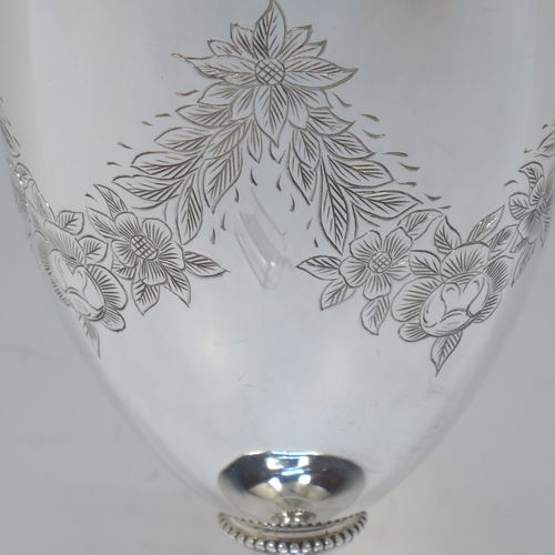 A very pretty Antique Victorian Sterling Silver goblet, having a round bellied body with hand-engraved swags of floral decoration, a gold-gilt interior, and sitting on a pedestal foot with an applied bead-edged border. Made by James Dixon and Sons of Sheffield in 1877. The dimensions of this fine hand-made antique silver goblet are height 18 cms (7 inches), diameter at lip 8.5 cms (3.3 inches), and it weighs approx. 224g (7.2 troy ounces).