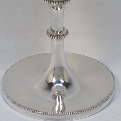 A very pretty Antique Victorian Sterling Silver goblet, having a round bellied body with hand-engraved swags of floral decoration, a gold-gilt interior, and sitting on a pedestal foot with an applied bead-edged border. Made by James Dixon and Sons of Sheffield in 1877. The dimensions of this fine hand-made antique silver goblet are height 18 cms (7 inches), diameter at lip 8.5 cms (3.3 inches), and it weighs approx. 224g (7.2 troy ounces).